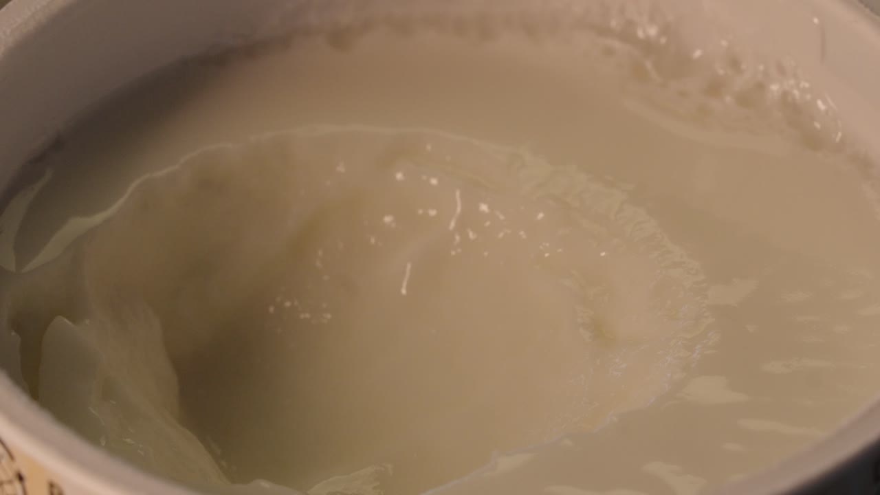 Macro Shot of a Spoon Dipping into a Pudding Cup - Creamy Dessert Delight