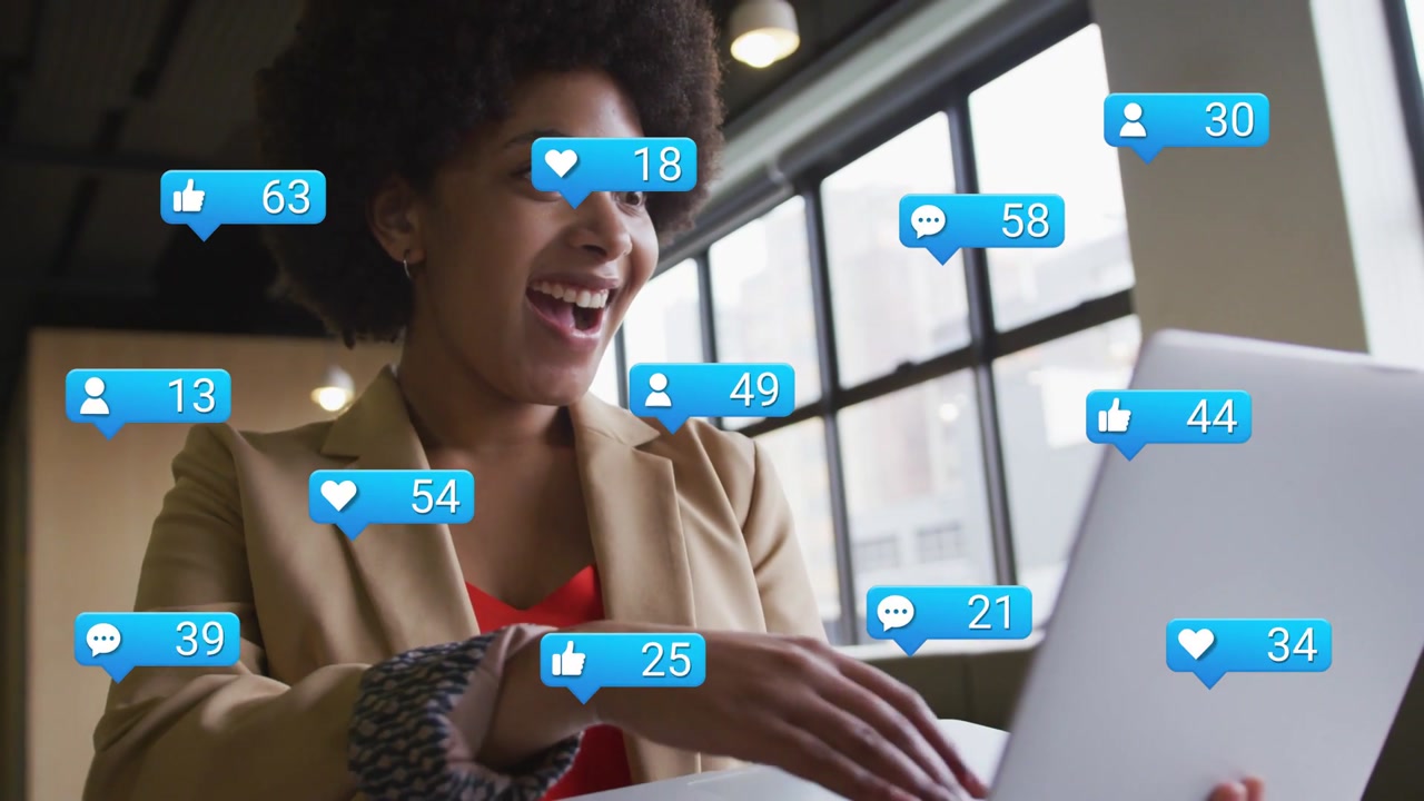 Woman tapping laptop in office, sparking blue bubbles growing around hands and raising social reach