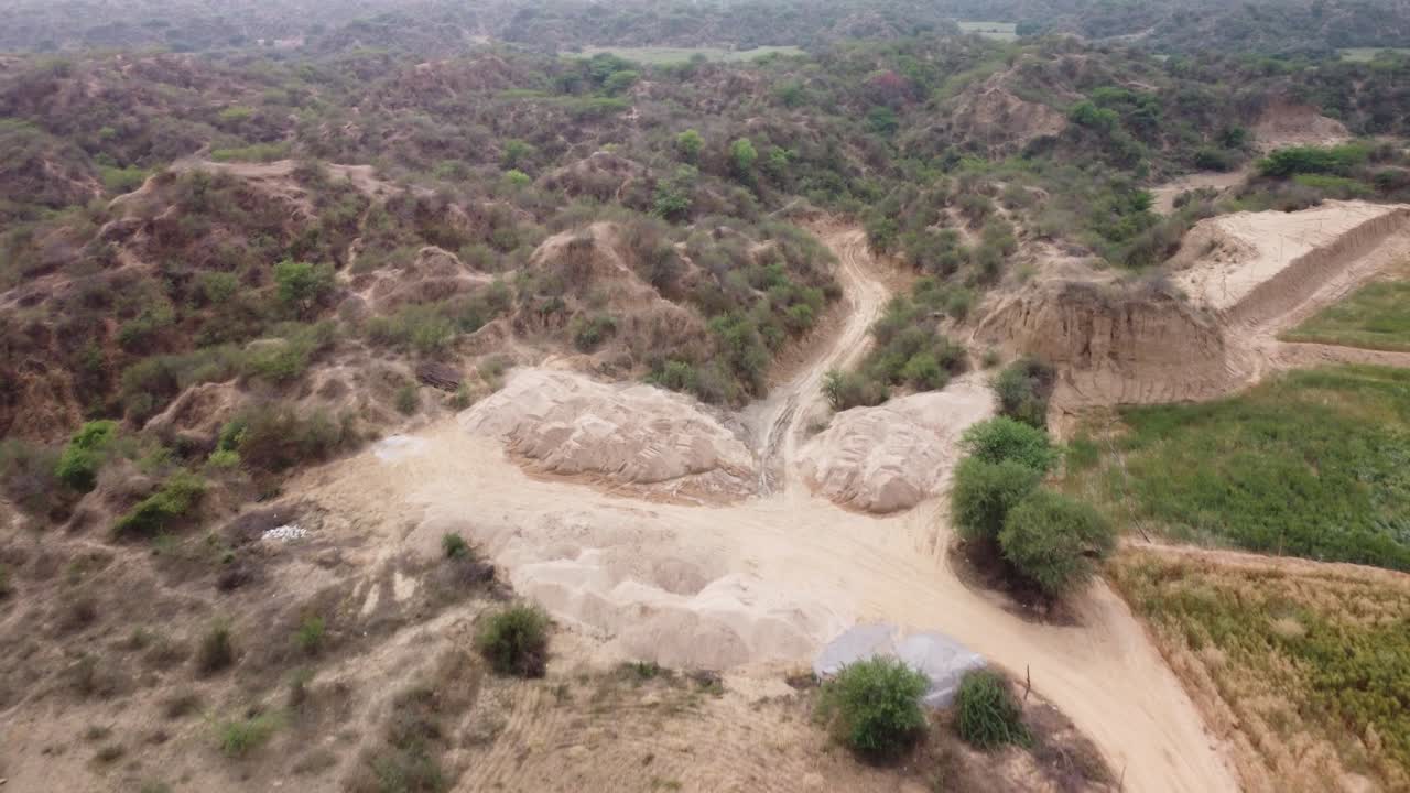 Drone flying over flat farmlands to reveal the unique gully erosion forming the iconic badlands of Chambal ravines in Morena plains on the Vindhyan Basin, India