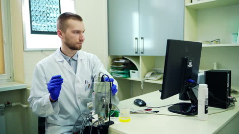 male scientists working on computer. doctor in lab in front of computer in hospital office