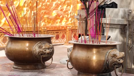 incense burners with vibrant sticks in hong kong temple