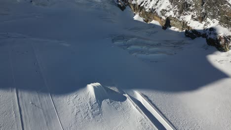 aerial-view-of-ski-slopes-with-snow-springboards-in-the-swiss-alps