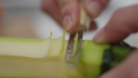 slicing cucumber finely with universal peeler