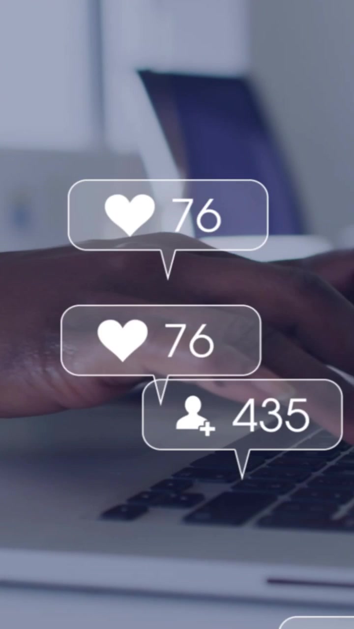 Woman's hands typing and using pad, causing social icons popping over keys monitoring metrics