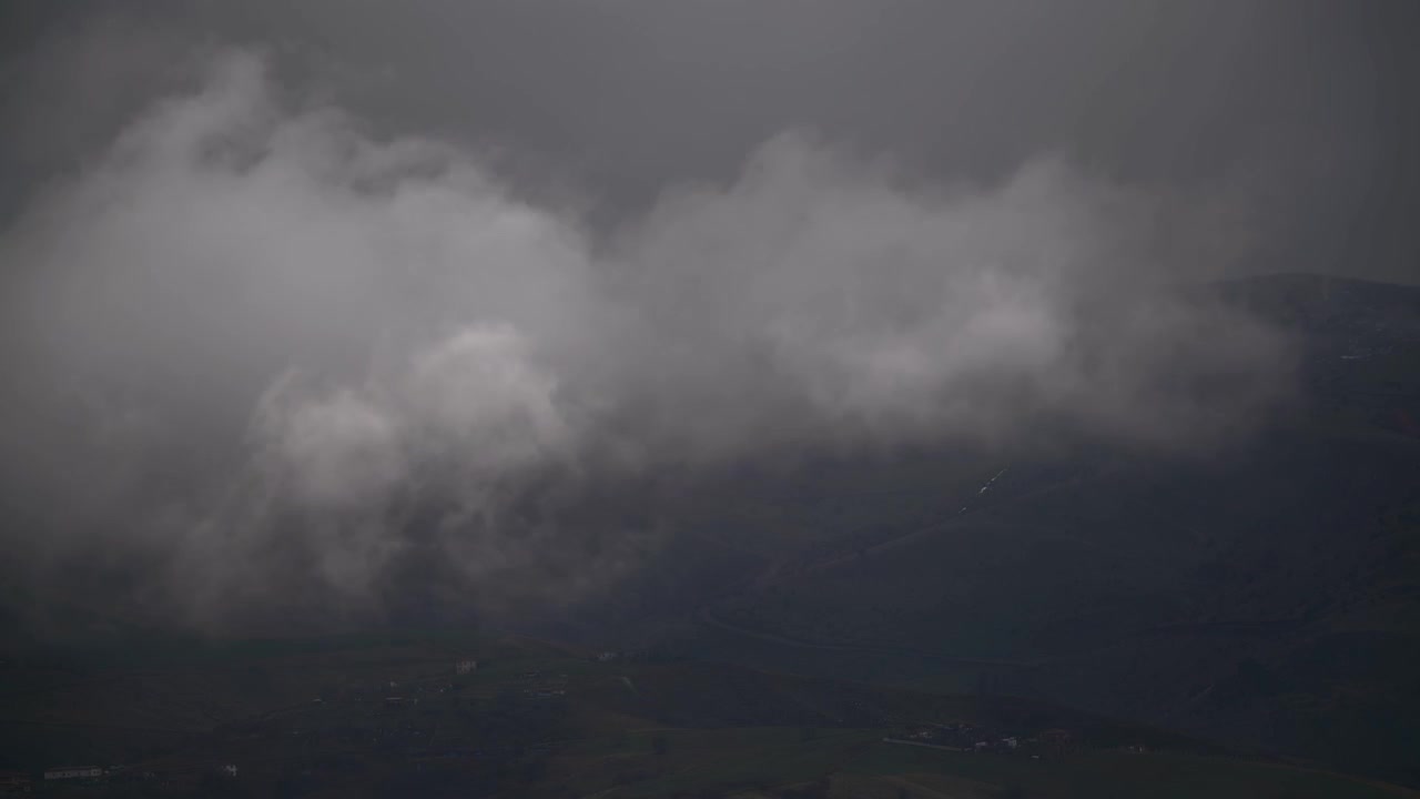 Thick Clouds Moving Over Dark Mountain Range