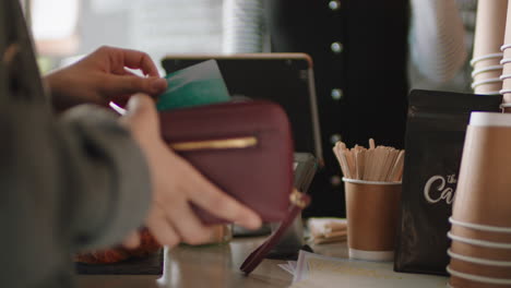 close up customer paying using credit card contactless payment spending money in cafe with digital transaction service