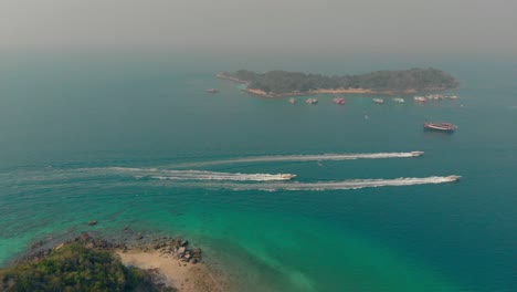 launches float between tropical forest islands among ocean