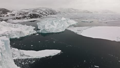 drone over sea and ice of ilulissat icefjord