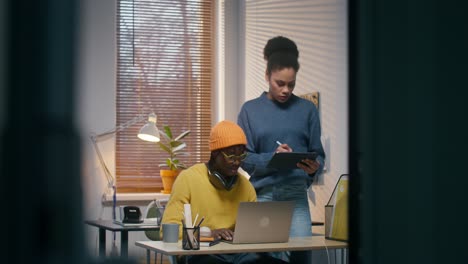 two people working together in a home office