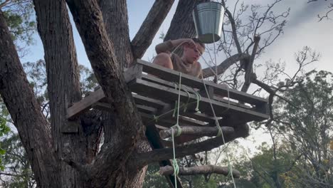 an inventive child uses a rope to tie