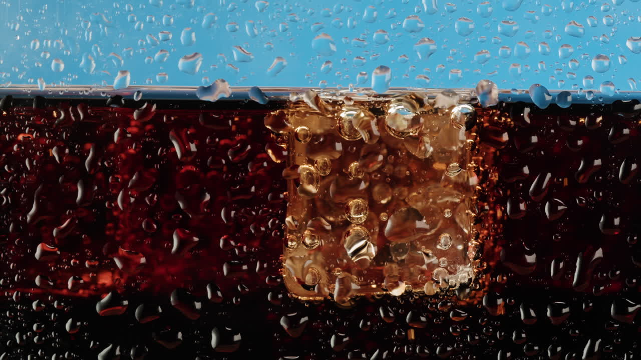 Close-up of a soda with ice and water droplets