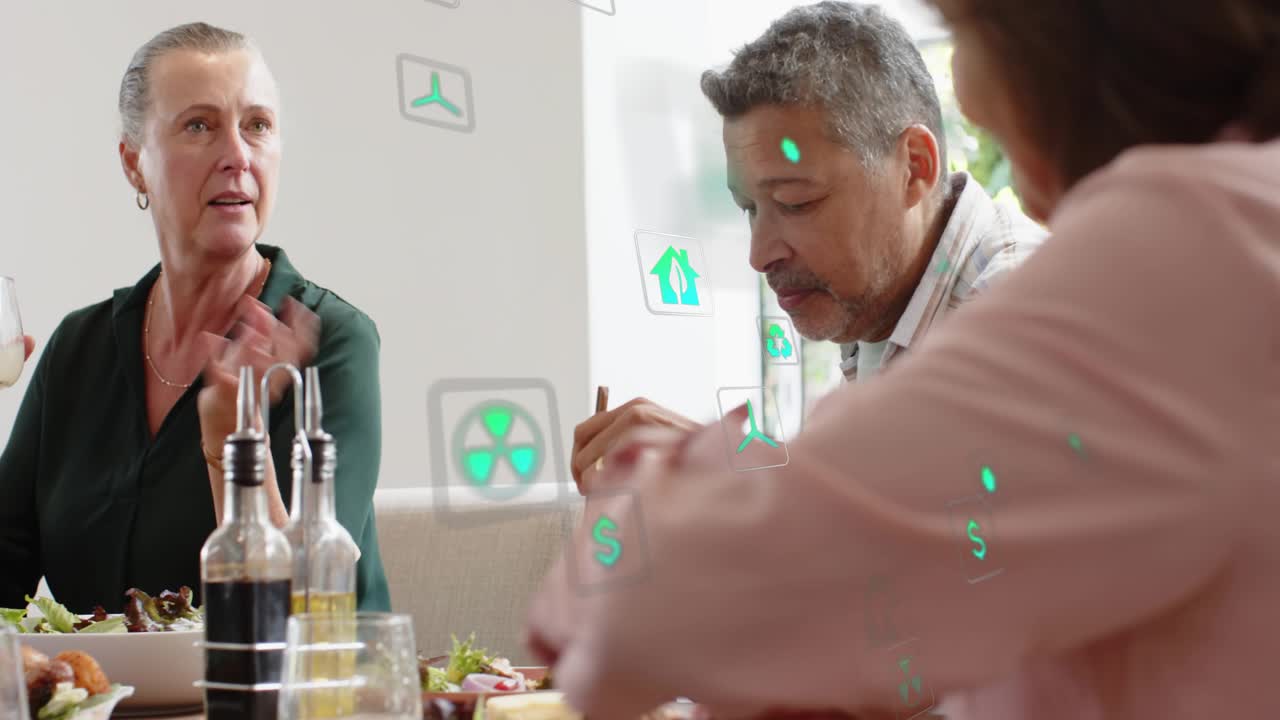 Woman in green holding glass and speaking, chatting and laughing, initiating tech icons over table