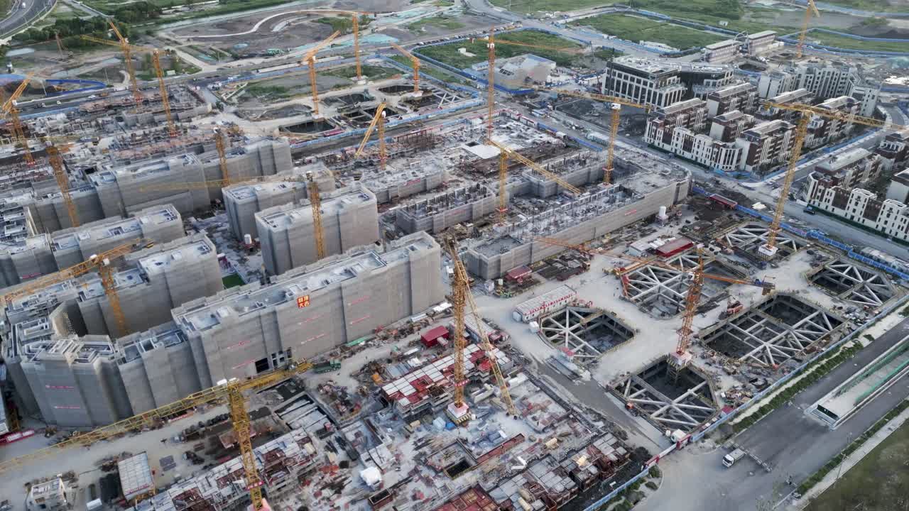 aerial view of huge construction site with yellow crane