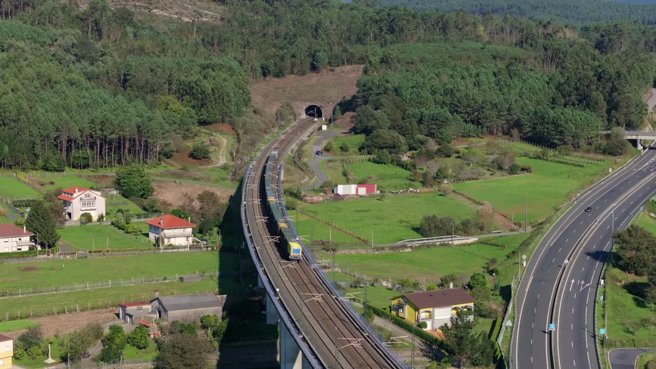 Aerial View of a Train on a Bridge Crossing a Highway