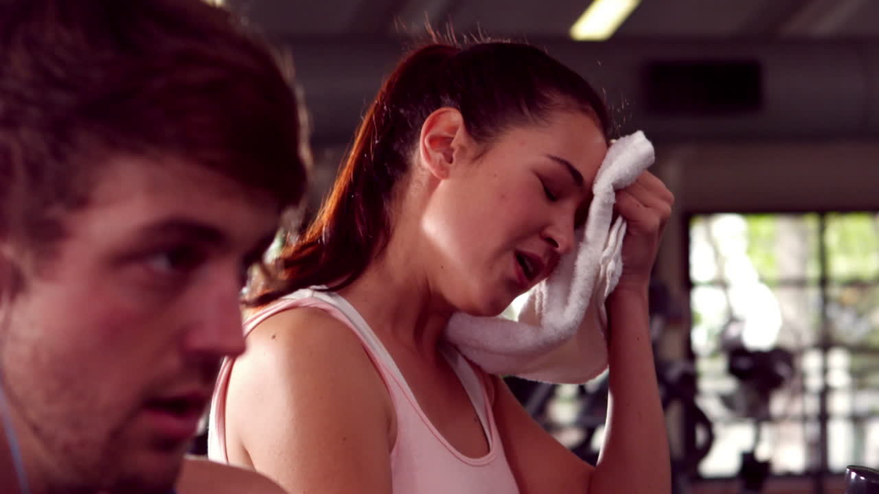 Fit people doing exercise with elliptical machine