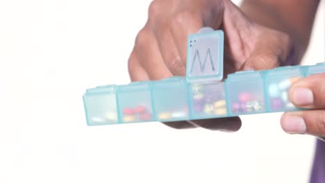 person using a pill organizer