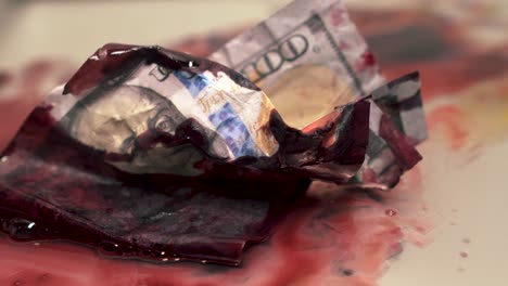 dripping blood money goo paint dramatic scene close up one hundred dollar bill