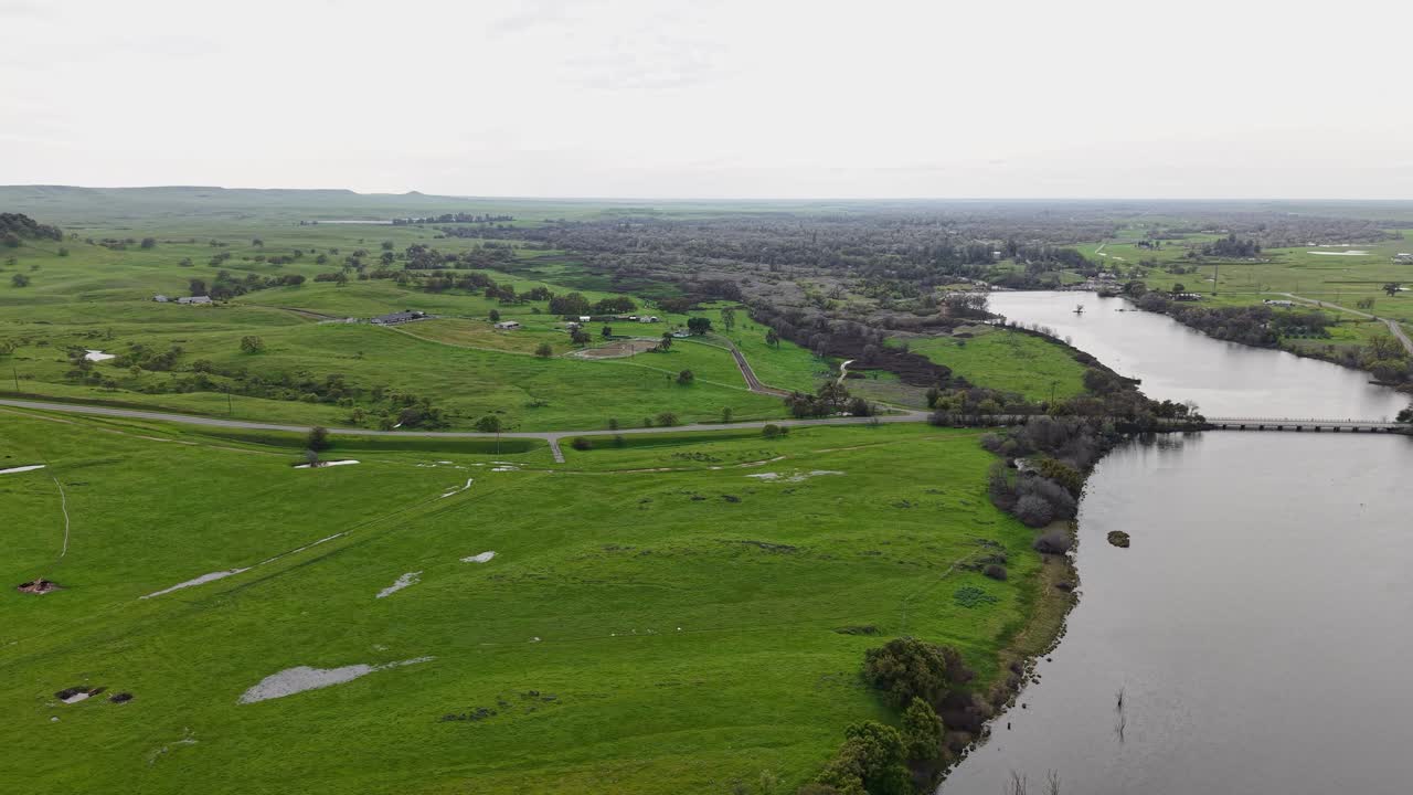 Merced Bridge is seen in the distance, revealing how it fits into the rolling terrain of Merced Falls.