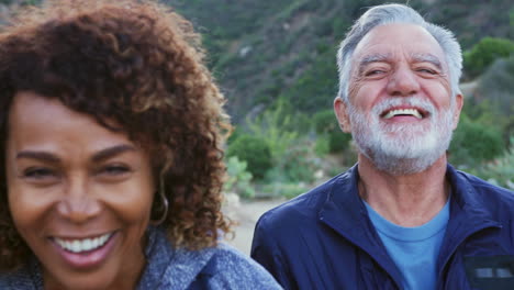 Portrait-Of-Group-Of-Smiling-And-Laughing-Senior-Friends-On-Hike-In-Countryside