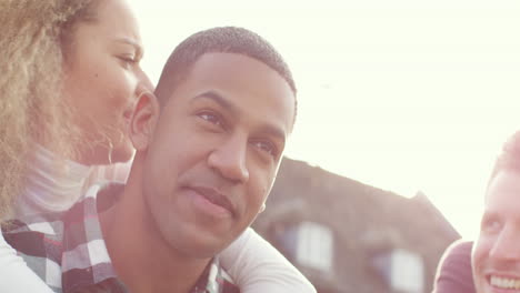 Man-Gives-Woman-Piggyback-on-Sunny-Day