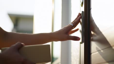 a hand delivers a package to a doorstep, capturing the moment of anticipation and connection in the art of delivery and receiving with a warm glow