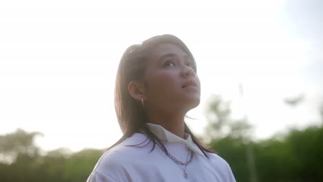 closeup of a beautiful teen girl in defocus nature.