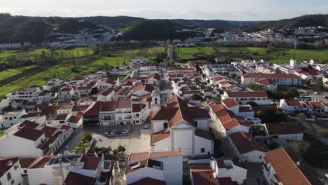 aerial view of traditional village of aljezur in portugal, orbiting cityscape