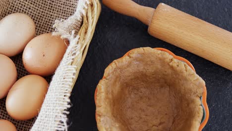 Eggs-in-wicker-basket-with-dough-4k