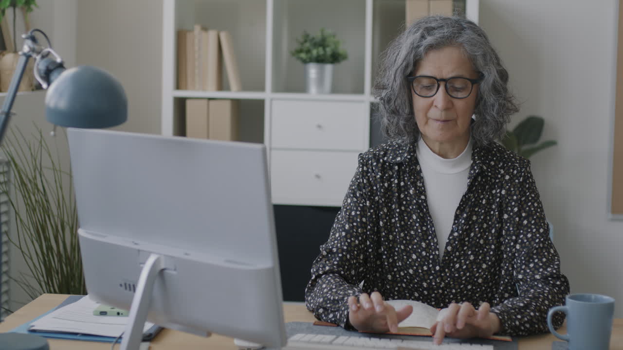 Senior Woman Working on Computer in Office