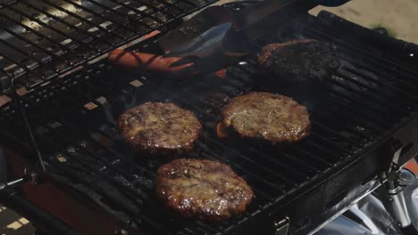 Sausage-And-Burger-Steaks-Grilled-Over-The-Charcoal-On-The-Barbeque-Griller