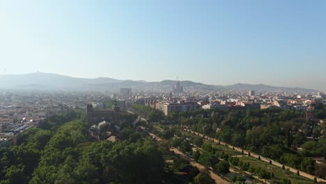 misty skyline of barcelona on sunny day, aerial descend view