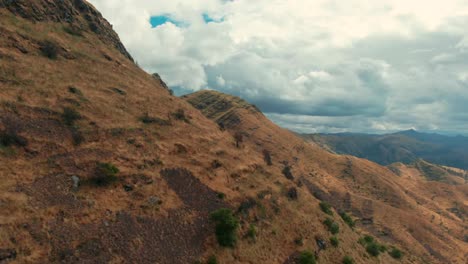 Mesmerizing-aerial-of-golden-summits-in-the-Peruvian-Andes,-Huanacaure-trek-near-Cusco,-dolly-in