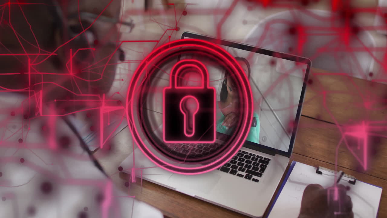 Red lock icon animation over open laptop on wooden desk