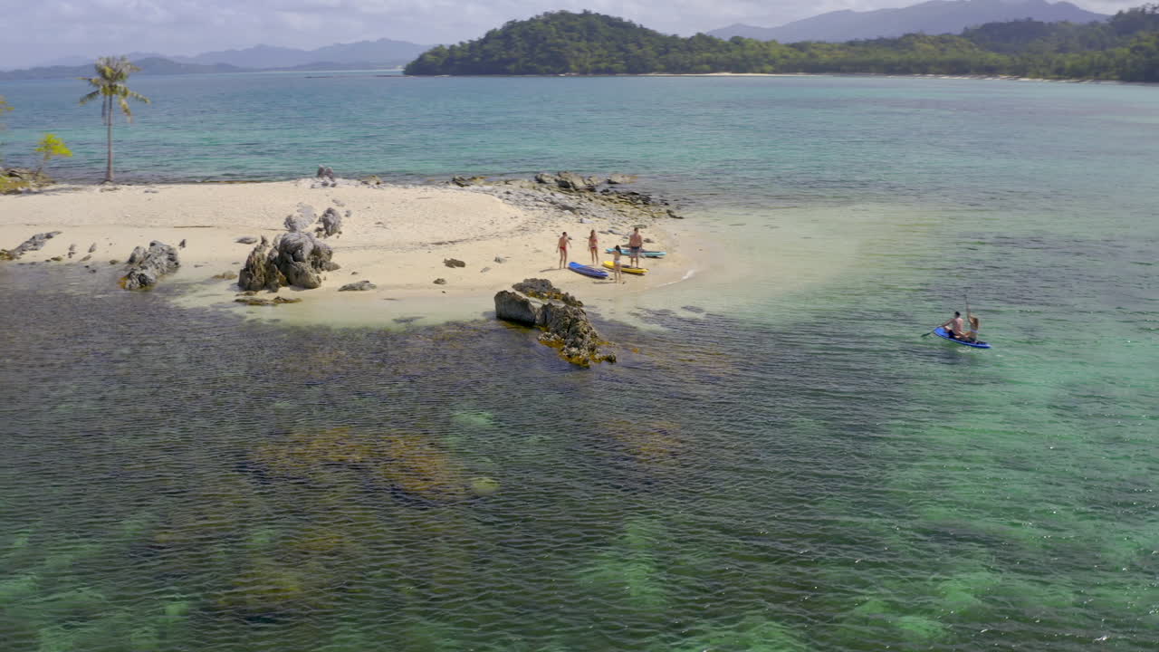 People enjoying watersports and a tropical beach paradise