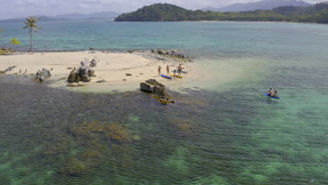 people enjoying watersports and a tropical beach paradise