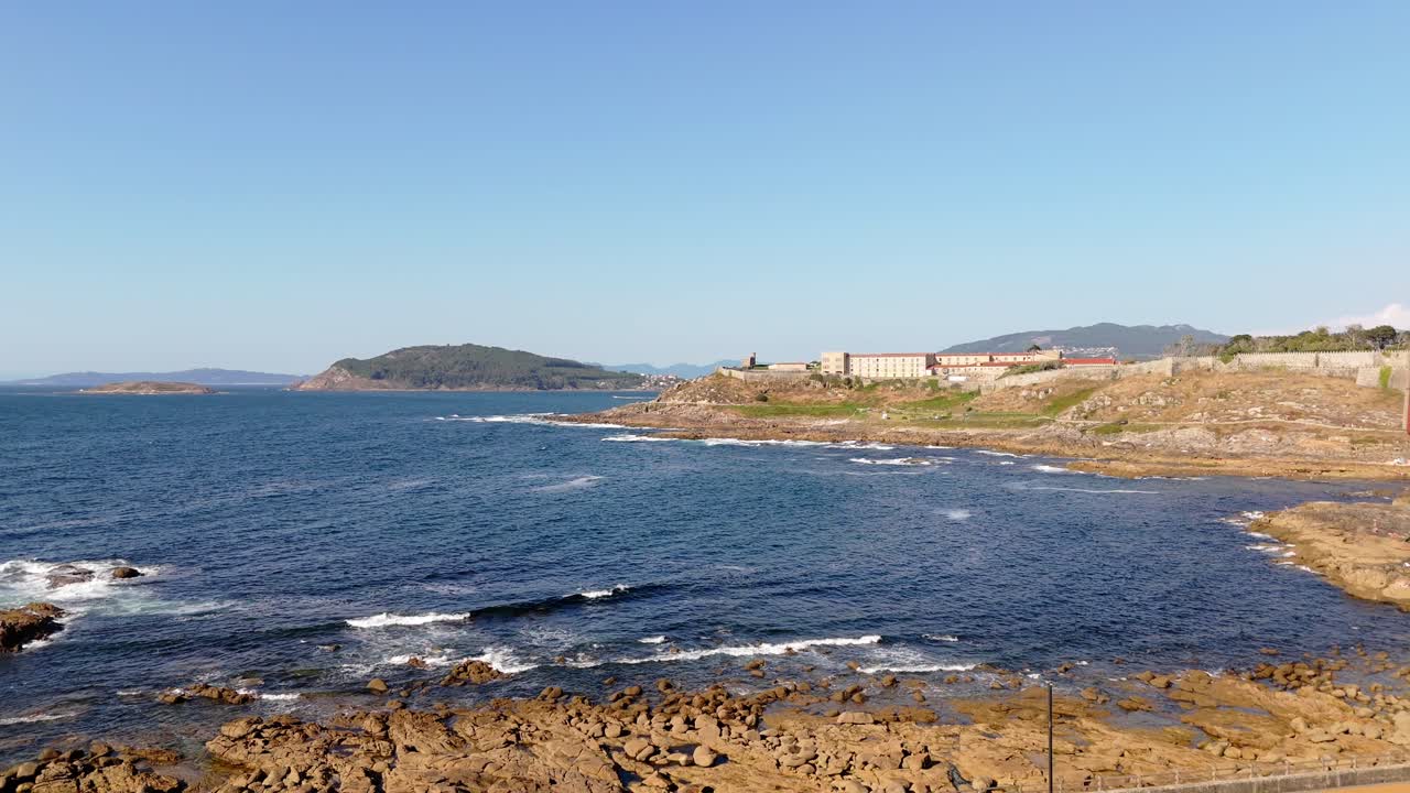 aerial - view of Monterreal Castle on the Baiona coastline, surrounded by rocky shores