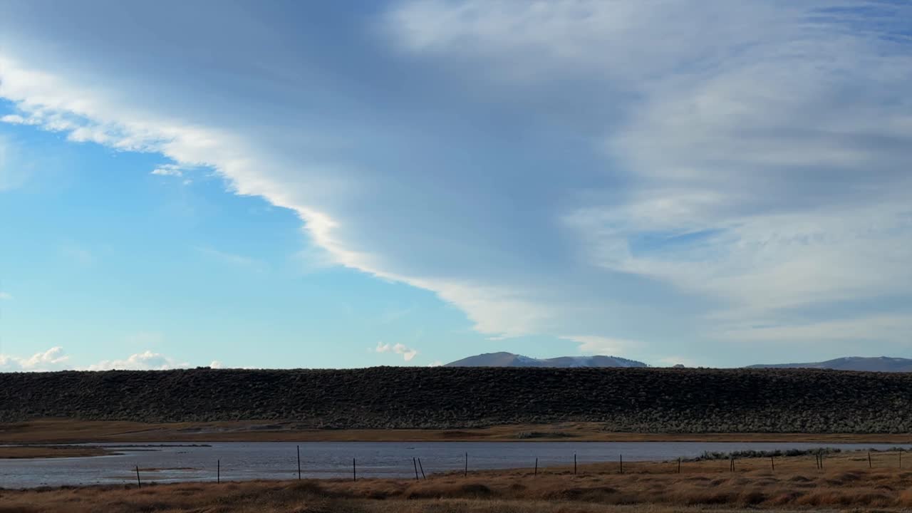 Sierra Mountain lenticular wave cloud Mammoth Mountain Lakes California Hilltop Willy's Whitmore natural hot springs Benton Crossing road Mount Morrison Bishop blue sky sunny afternoon slow pan left