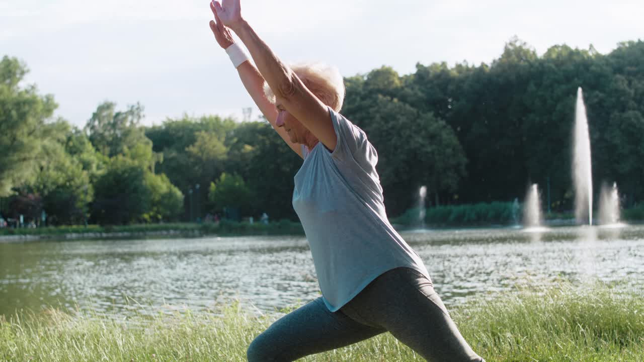 Senior woman practicing yoga in the sunset