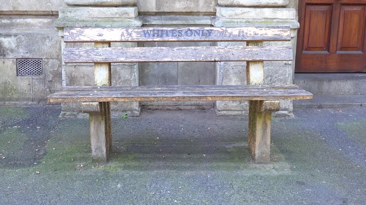 A bench sayings whites only along a street in Cape Town South Africa remembers the Apartheid era of segregation racism and separation of whites and blacks 2
