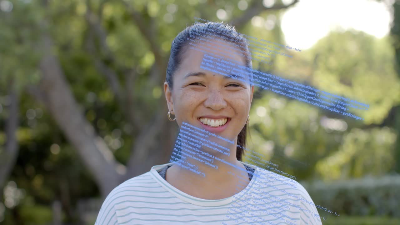 Woman smiling in sunlit park frames advancing sweeping blue code panels across face for tech demo