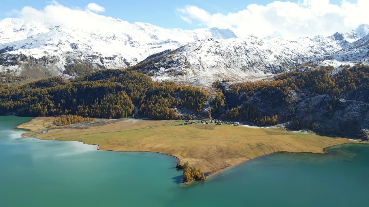 Drone shot of the Lake Sils in Autumn (Silsersee) Isola in Upper Engadine, Grisons, Switzerland.