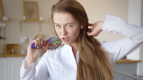 woman singing with a colorful hairbrush