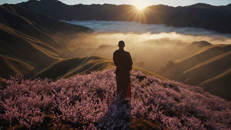 monk contemplating sunrise over mountain valley