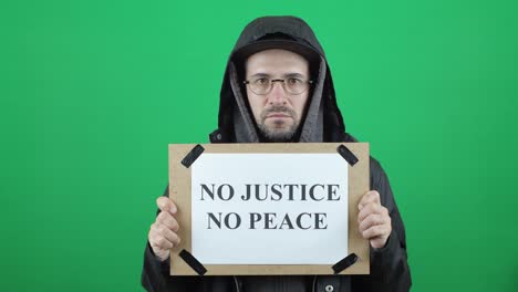 no justice no peace. white, european man with the inscription and the inscription "no justice no peace" on a green chroma key background