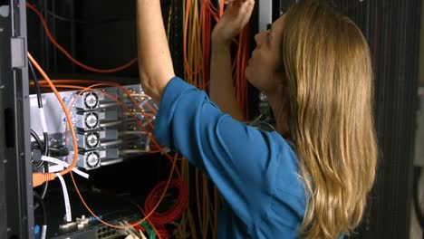 technician looking at open server locker