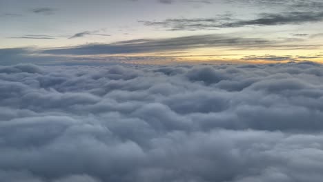 clouds scene at dawn flying over a sea of clouds, as seen by the pilots in a real flight at 10000m high