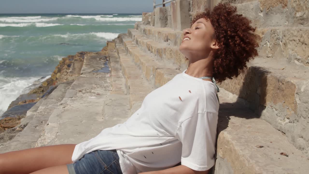 Woman relaxing at beach on a sunny day 4k