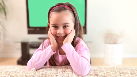 Smiling-girl-sitting-on-a-couch