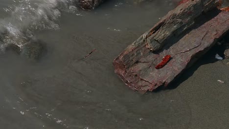 close up of water moving over rock and sediment in denali national park, alaska, usa