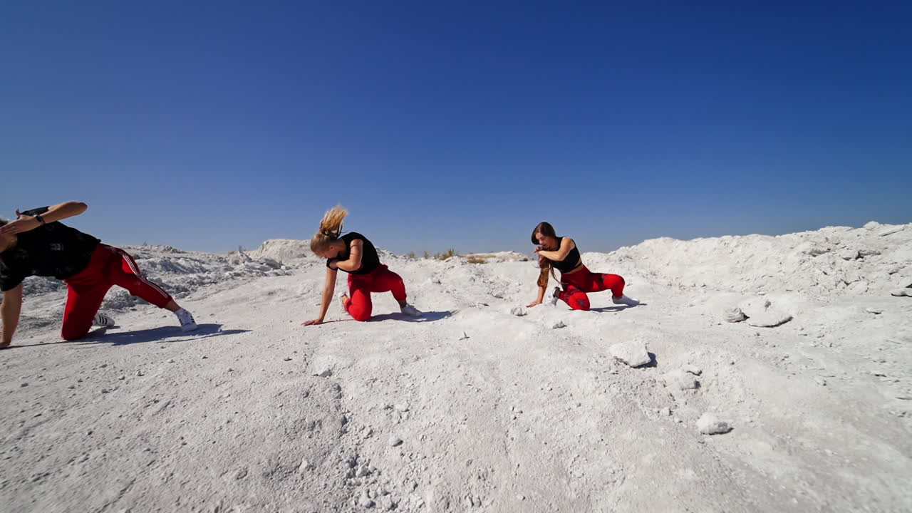 Three young women dancing outdoors